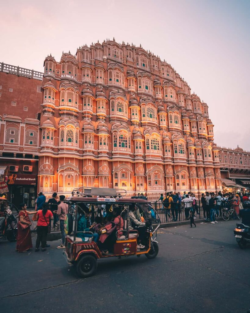 Hawa Mahal at dusk with the street and traffic in front of it