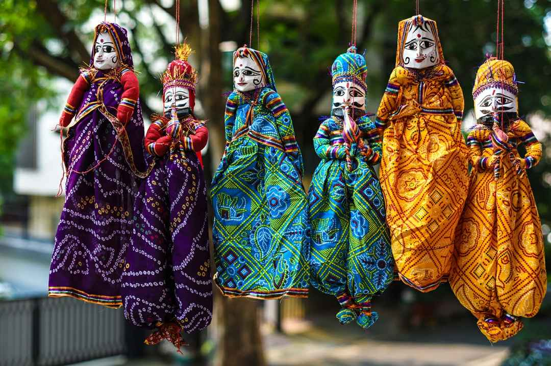 Kathputli puppets in traditional dress hanging in the open air